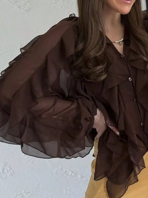 Brown sheer long-sleeve blouse with cascading ruffles and button front.