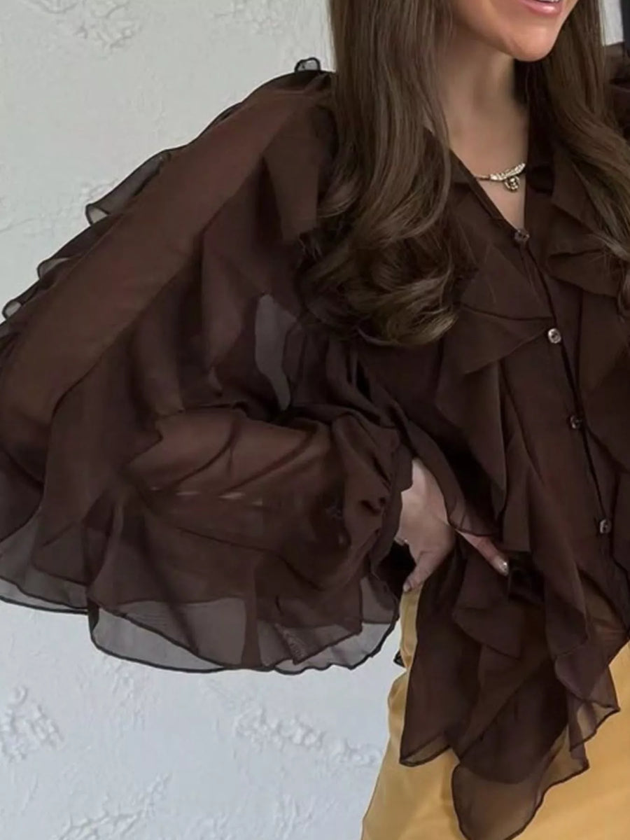 Brown sheer long-sleeve blouse with cascading ruffles and button front.