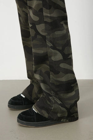 Camo flare denim trousers in green camouflage pattern.