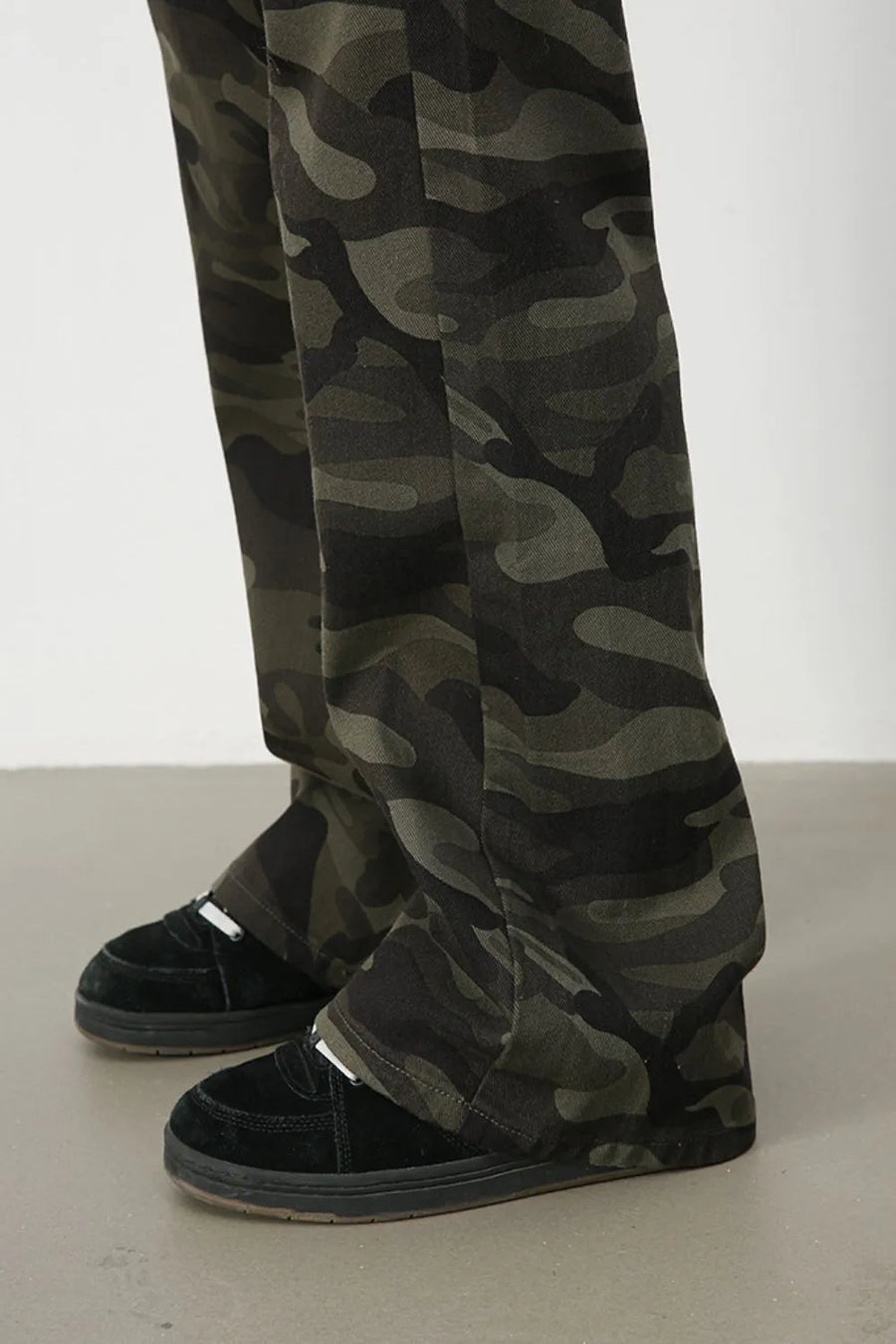 Camo flare denim trousers in green camouflage pattern.