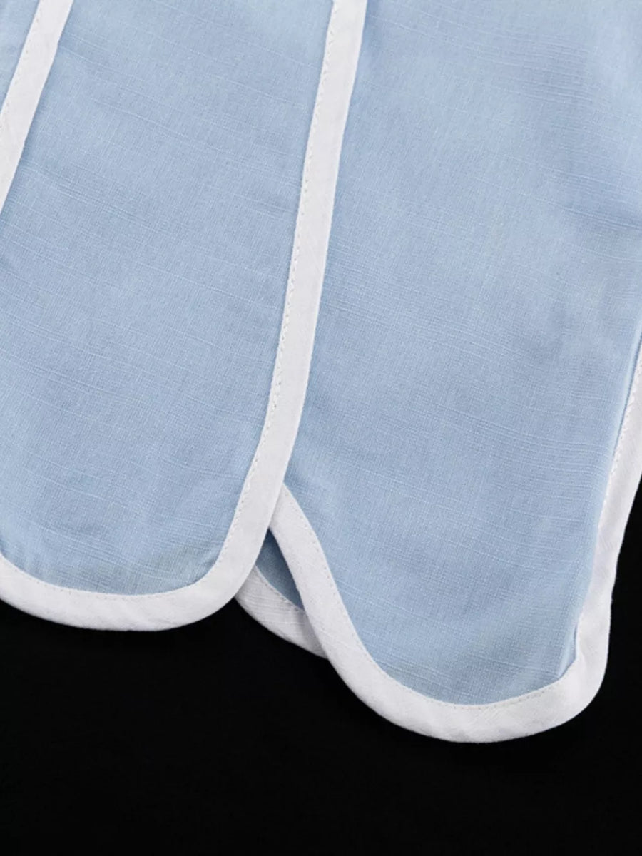 Light blue linen shorts with white trim and a scalloped hem.