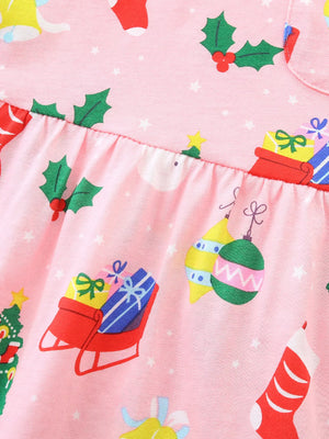 Pink long-sleeve baby dress with Christmas print, featuring gifts, ornaments, and holly.