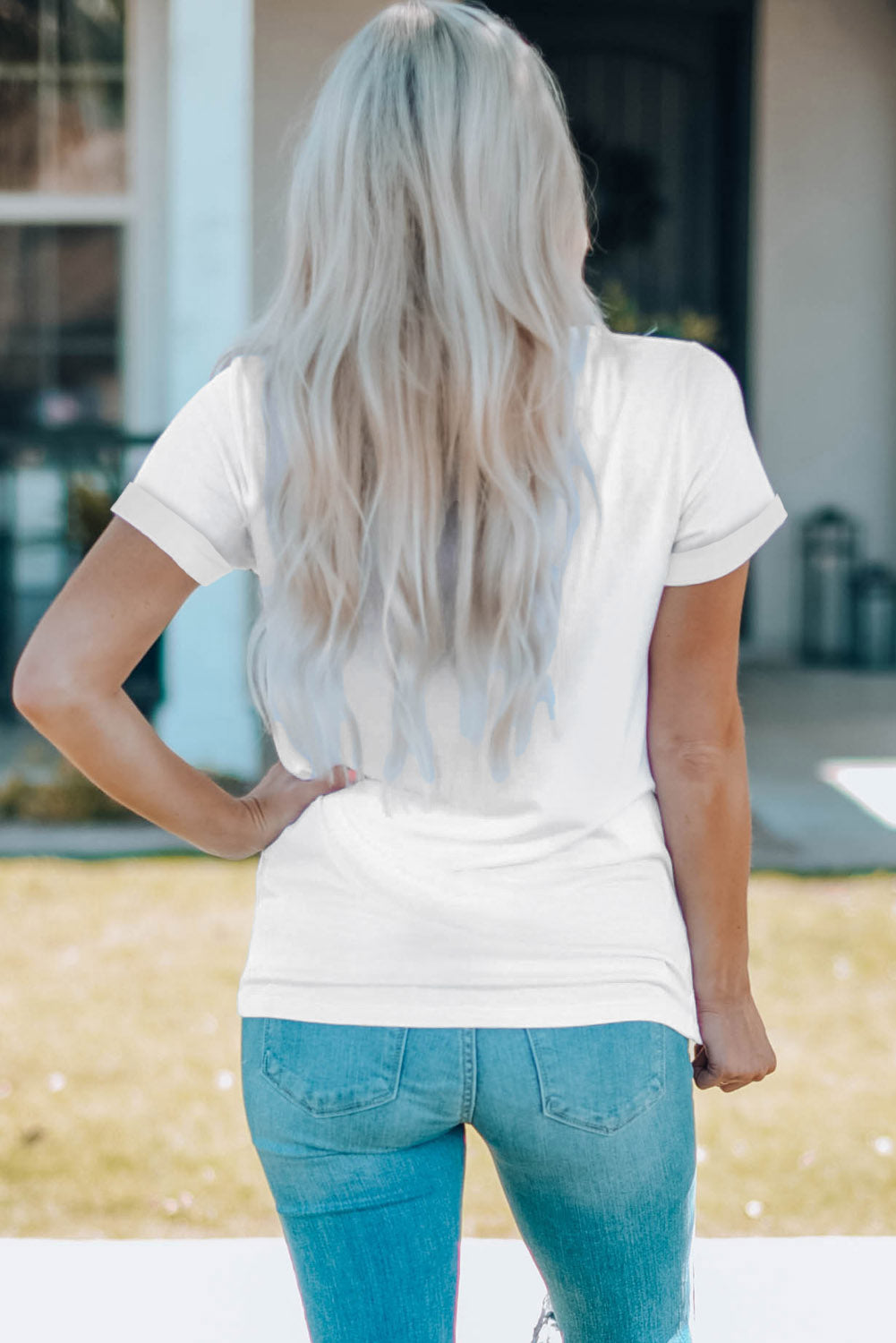 White graphic t-shirt with cuffed short sleeves and a casual fit.
