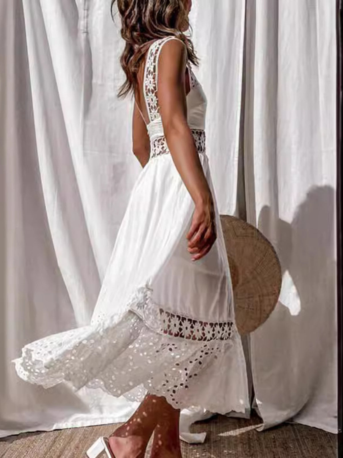 White openwork crochet sleeveless midi dress with cutout details and lace trim.