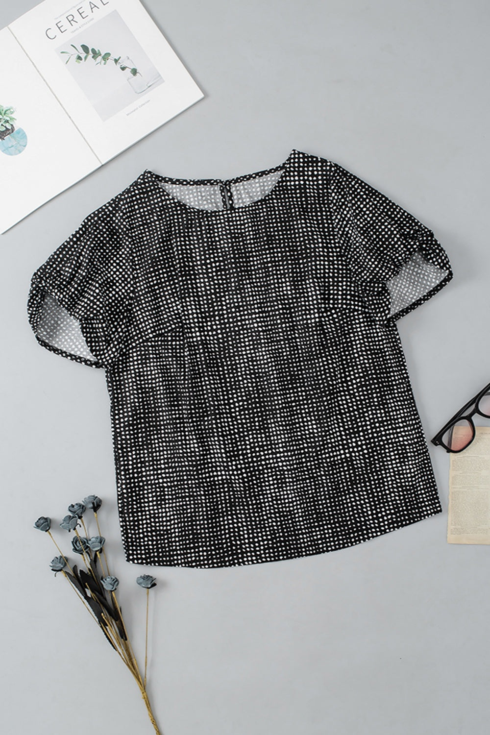 Black micro-dot puff sleeve blouse with round neckline and short sleeves