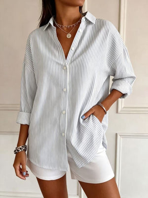 light blue button-down shirt featuring buttoned and striped
