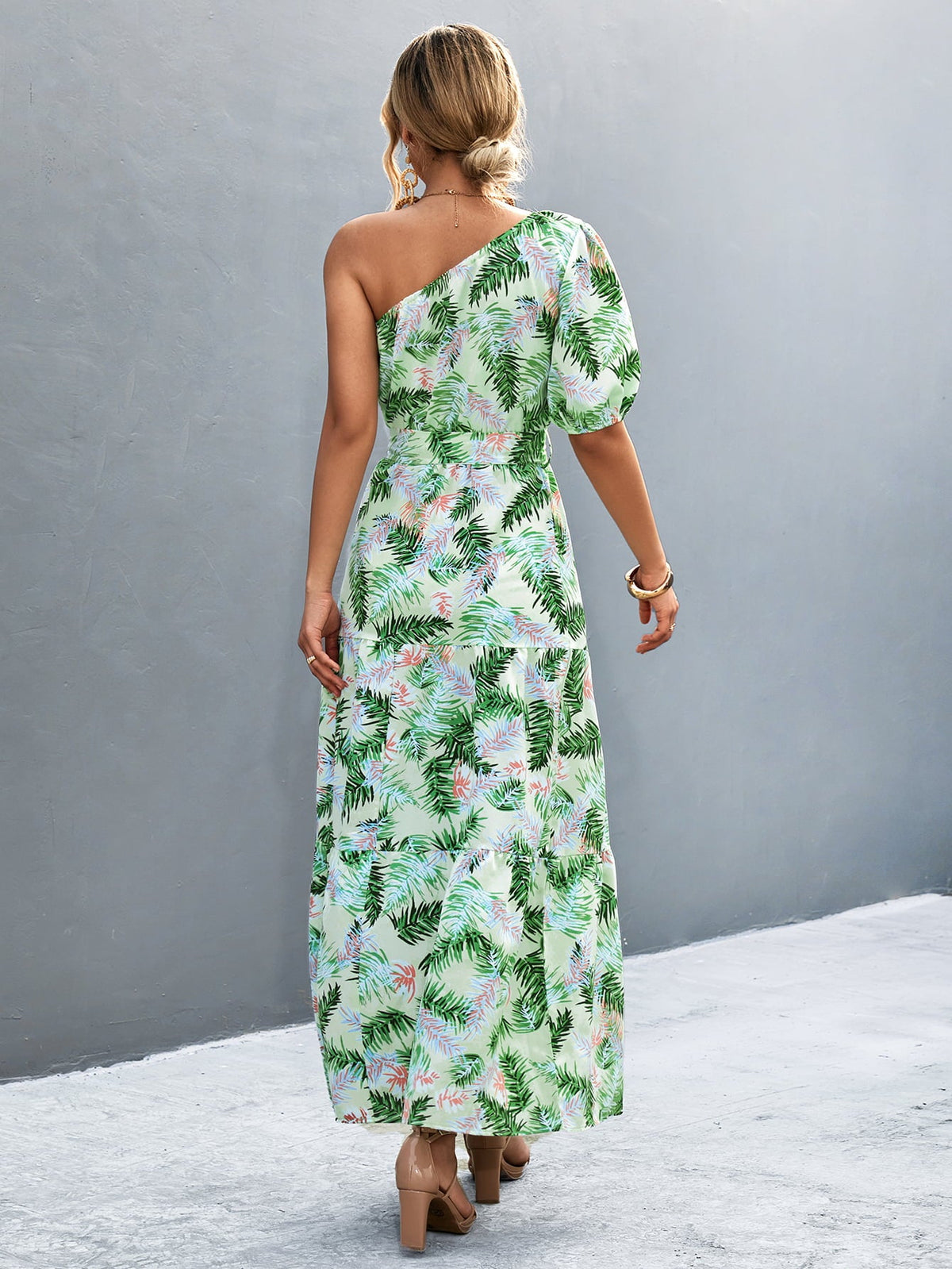 Light green tropical print one-shoulder maxi dress with balloon sleeves and tiered skirt.