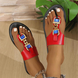 Red chain sandals with rhinestone embellishments and gold hardware.