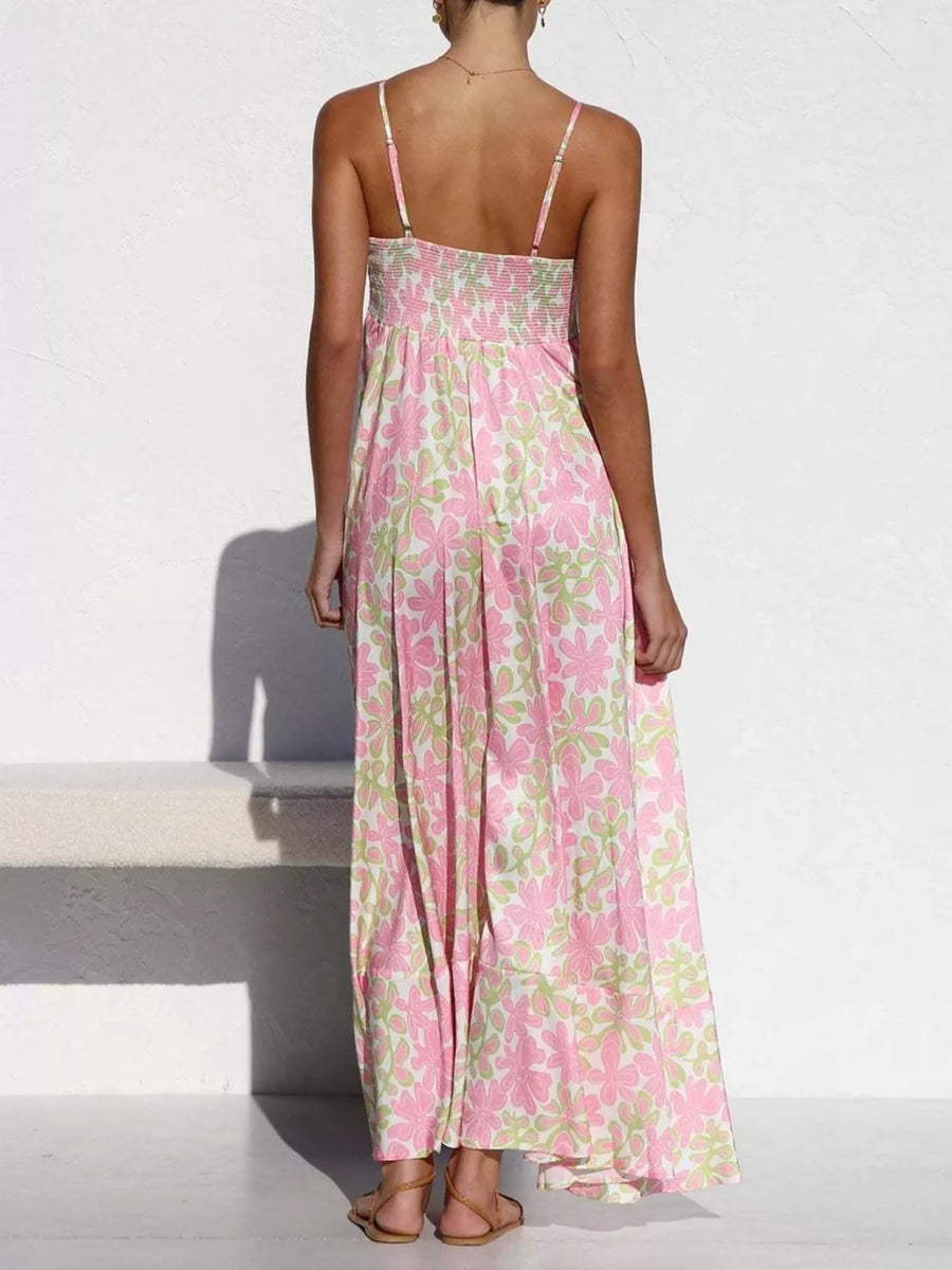 Maxi dress with spaghetti straps and a floral print in pink and green.