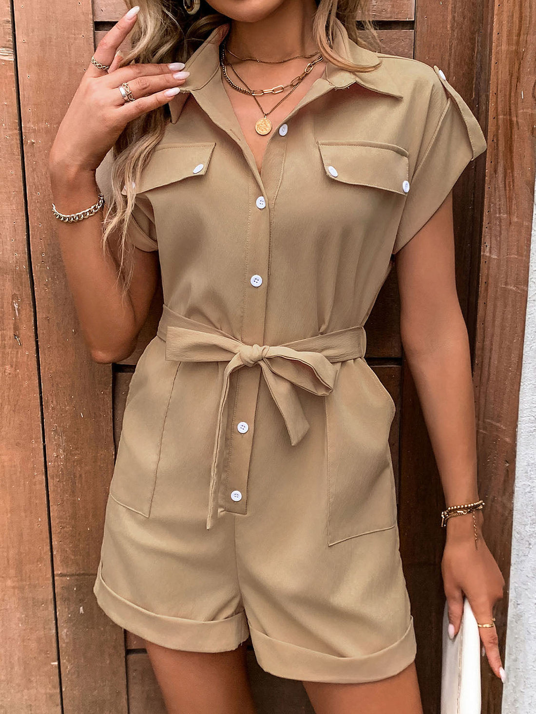 Camel utility romper with tie-waist, collared, short sleeves, and button-down front.
