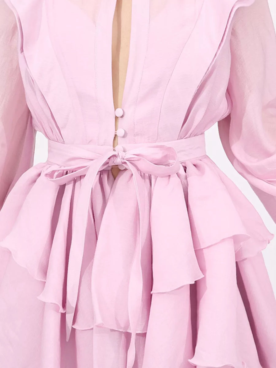 Pink tiered ruffle mini dress with button front and tie waist.