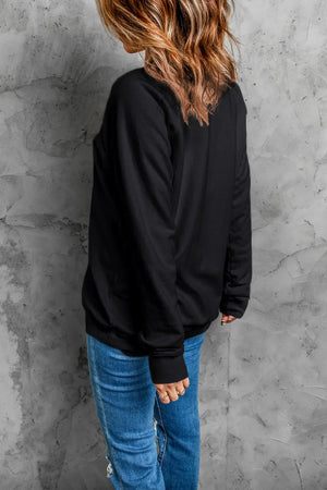 Black crewneck sweatshirt with glittered "Happy New Year" graphic on front