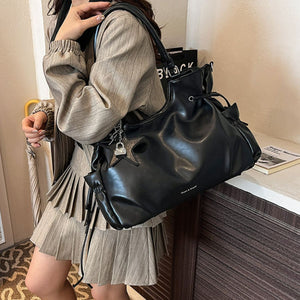 shoulder bag in black featuring drawstring details and slouchy fit