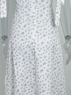 White floral tie shoulder midi dress with a button front detail.