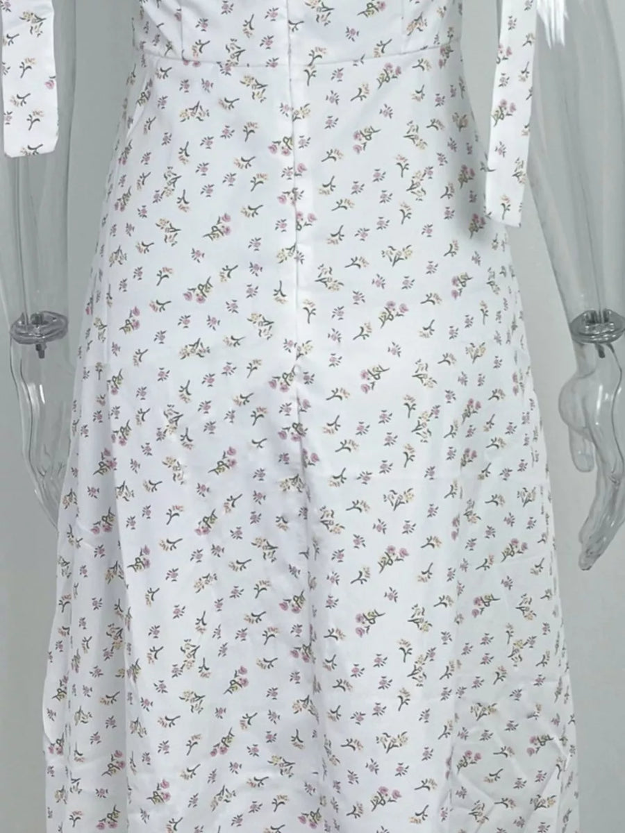 White floral tie shoulder midi dress with a button front detail.