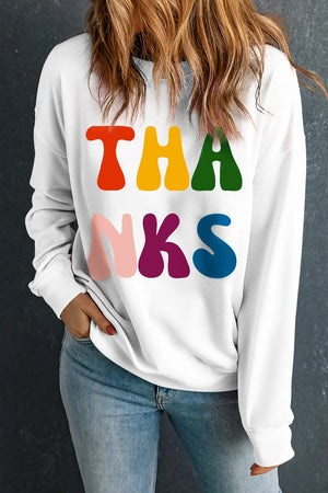 White graphic sweatshirt with retro "THANKS" text in colorful, rounded font.