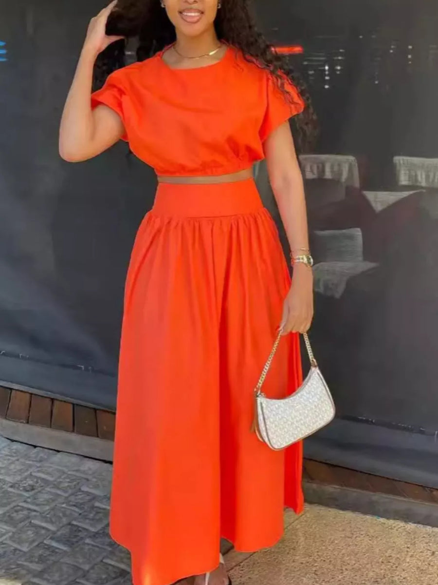 Orange crop top with puff sleeves and high-waisted maxi skirt set