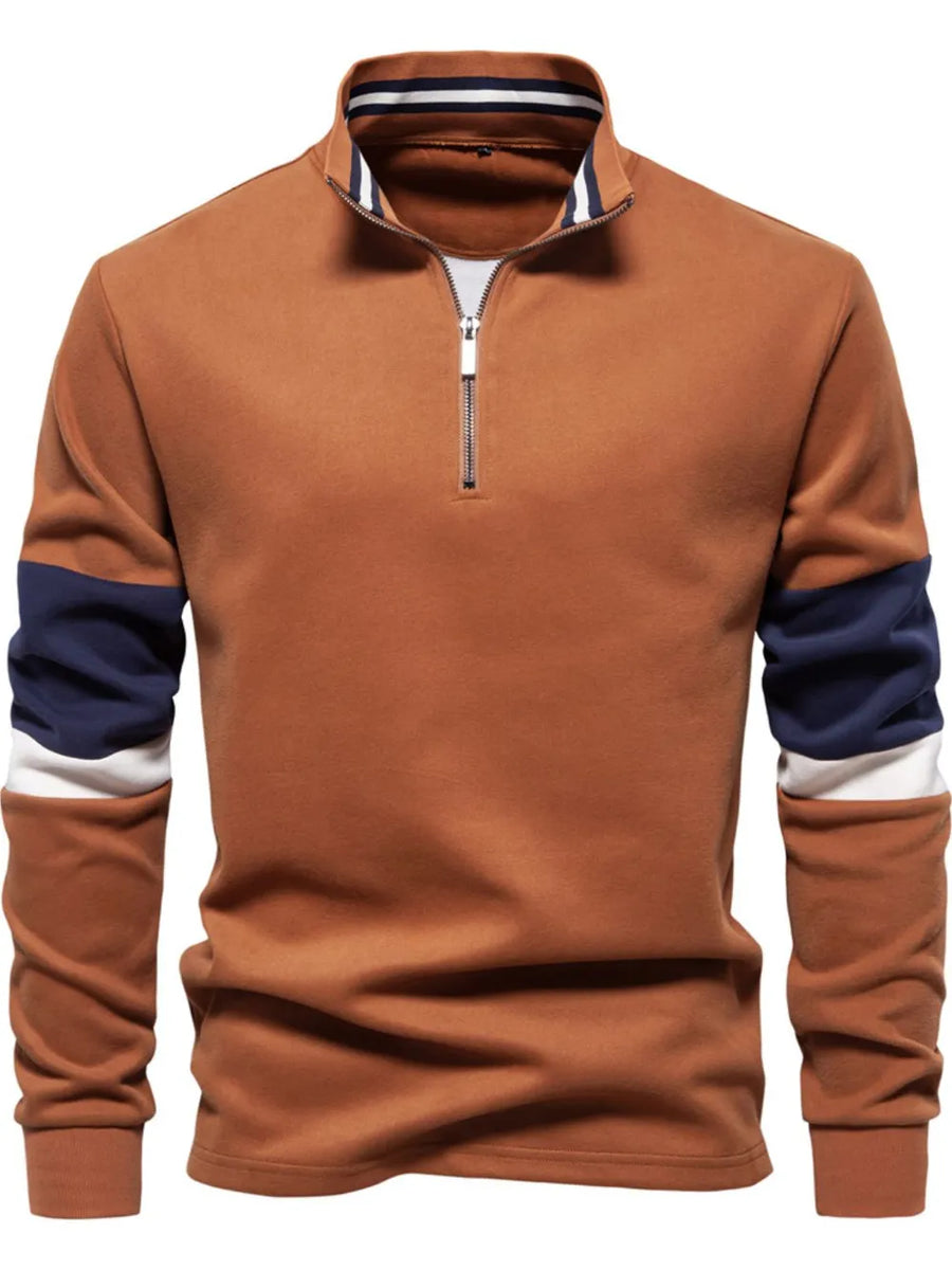 Caramel colorblock zip-neck sweatshirt with navy and white sleeve details.