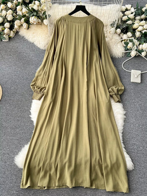 Khaki cotton maxi dress with tie neck and embroidered floral detail.