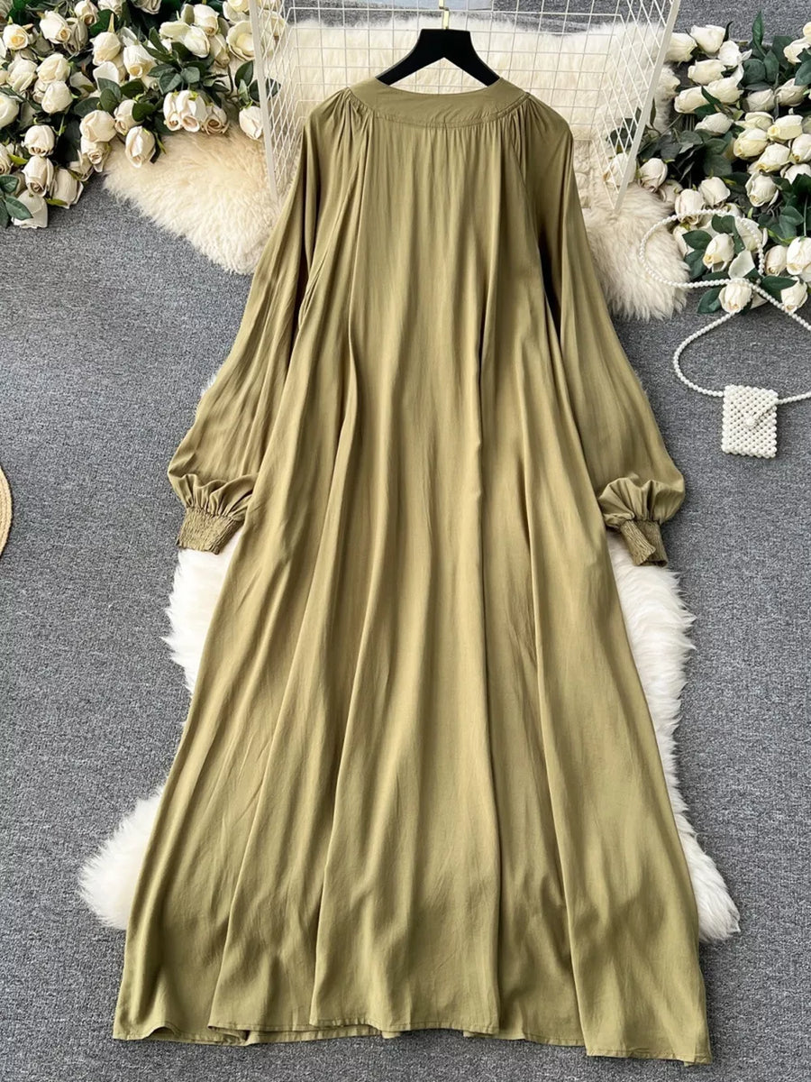 Khaki cotton maxi dress with tie neck and embroidered floral detail.