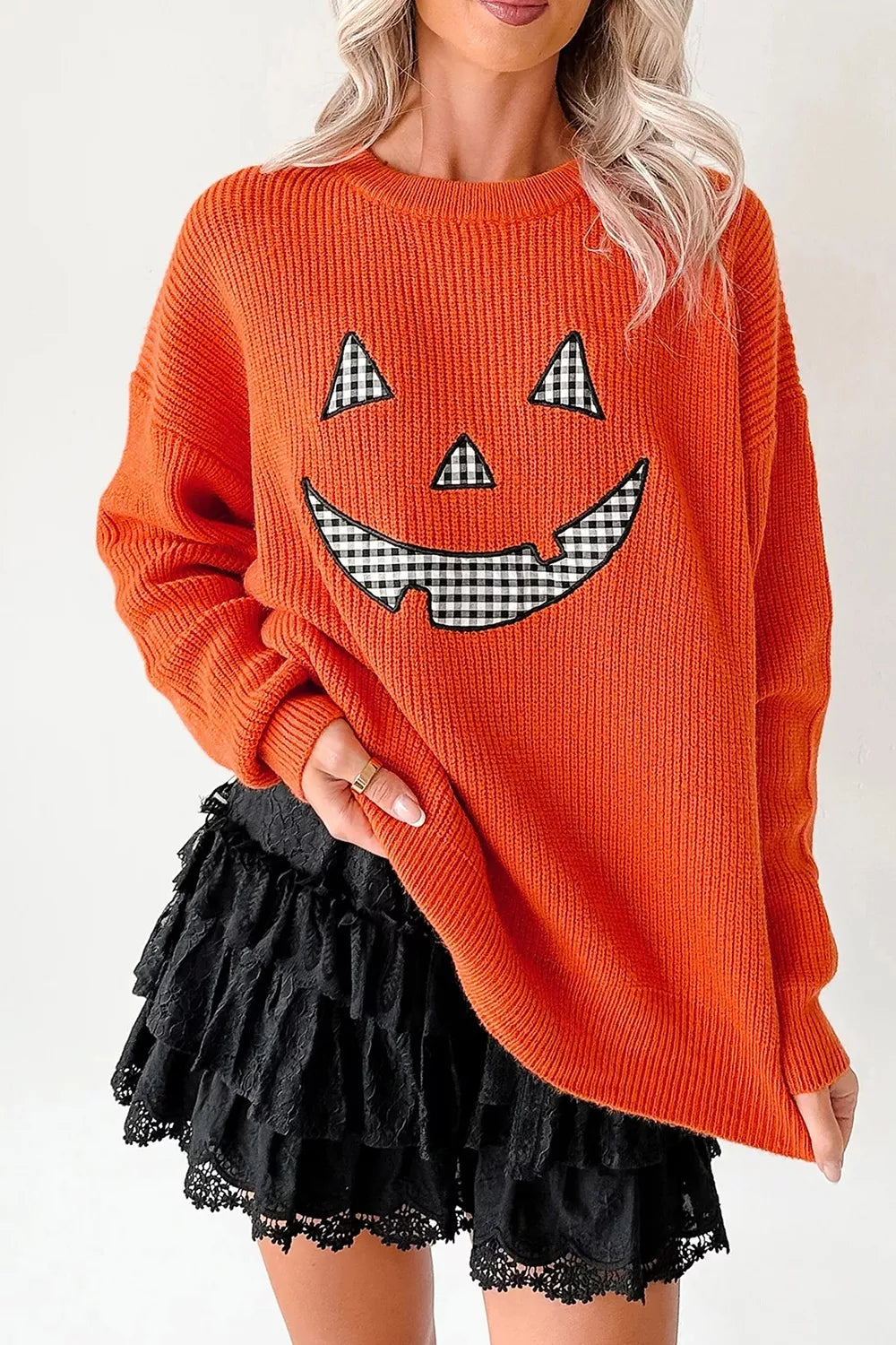 orange pullover sweater with graphic print and round neck