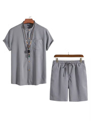 Grey buttoned short-sleeve shirt with mandarin collar and drawstring shorts.