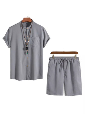 Grey buttoned short-sleeve shirt with mandarin collar and drawstring shorts.