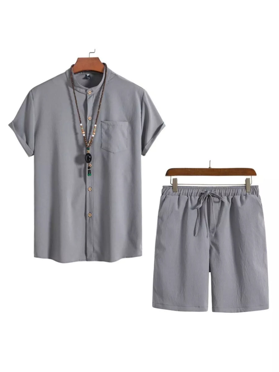 Grey buttoned short-sleeve shirt with mandarin collar and drawstring shorts.