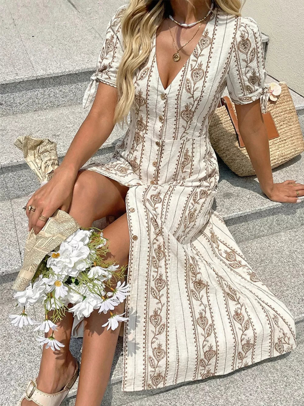 Printed button-down midi dress with short sleeves and a-line cut, featuring a bohemian floral pattern.