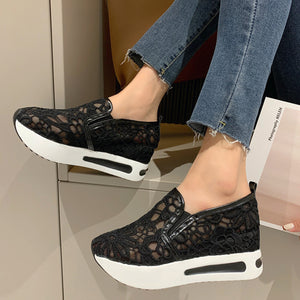 Black lace mesh slip-on flats with white platform soles and casual styling.
