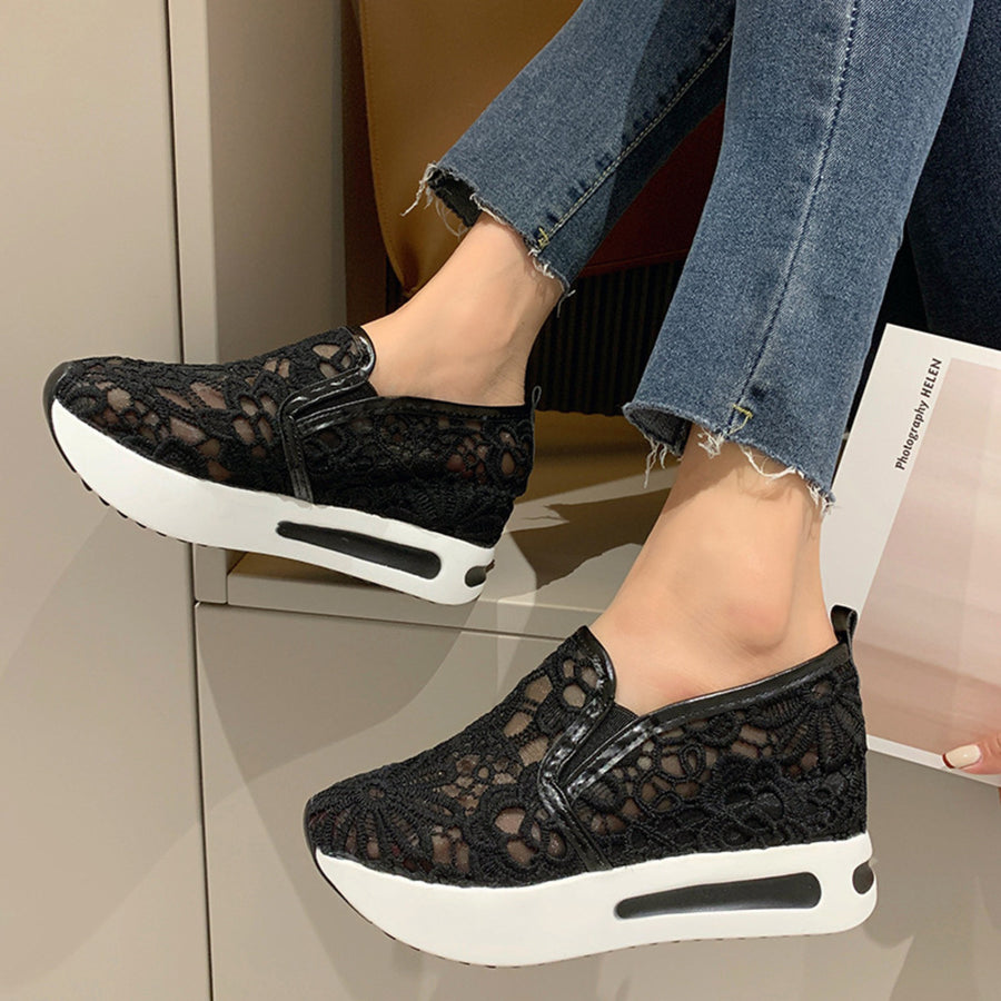 Black lace mesh slip-on flats with white platform soles and casual styling.
