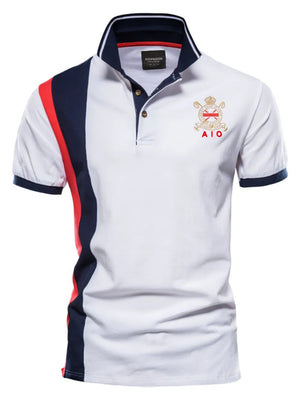 White polo shirt with navy and red colorblock sleeves and crest detail.