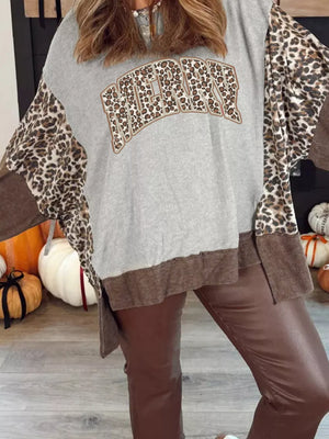 Leopard print graphic holiday sweatshirt with colorblock sleeves and distressed hem.