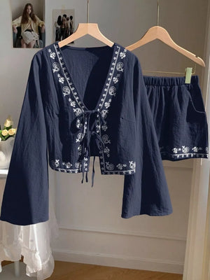 Navy embroidered tie-front top with bell sleeves and matching shorts set