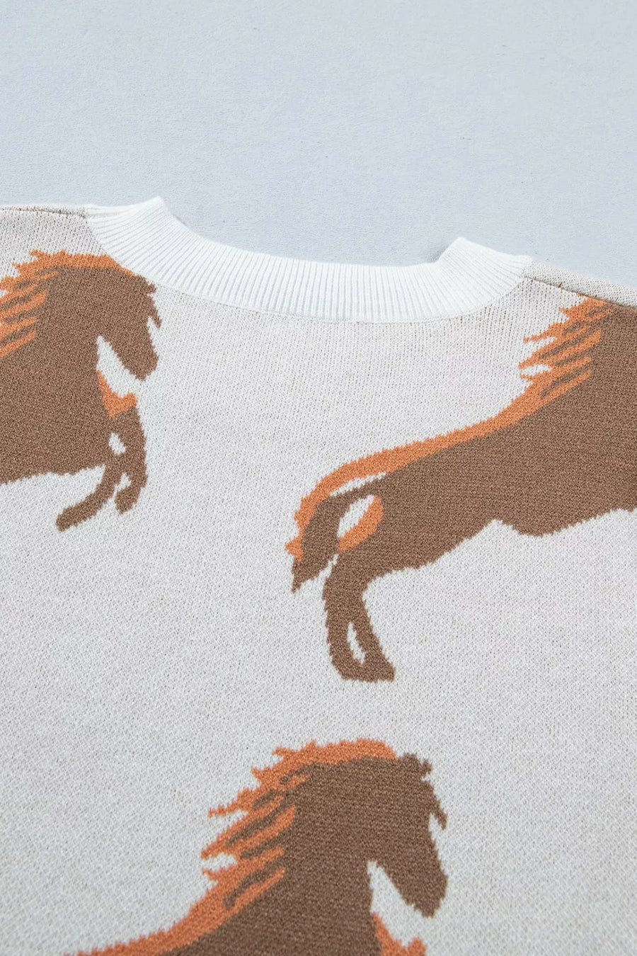 Beige knit sweater with horse graphic and crew neck.