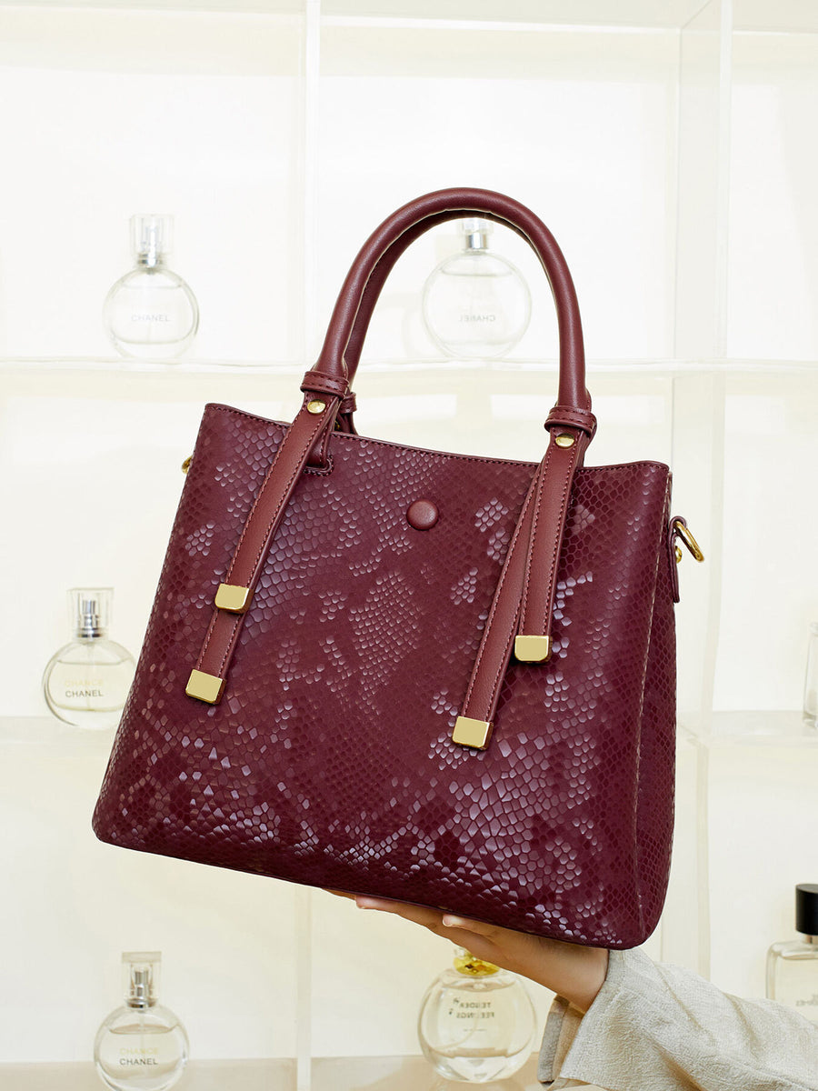 burgundy handbag with magnetic snap and snakeskin