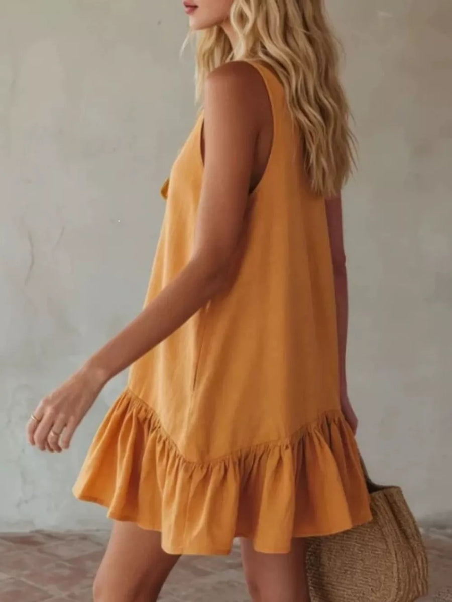 Turmeric tie-front mini dress with ruffle hem and sleeveless design.