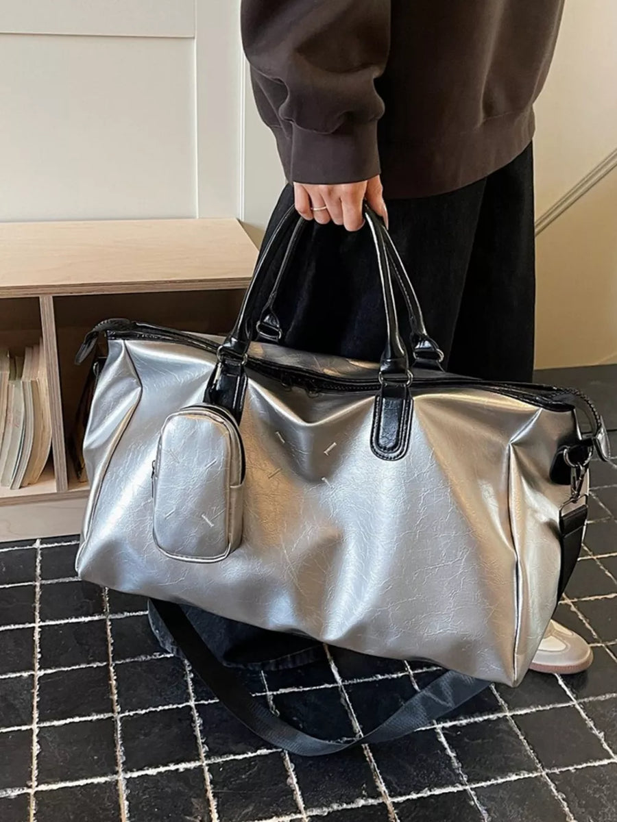 Sleek metallic silver large travel bag with detachable pouch and adjustable strap.