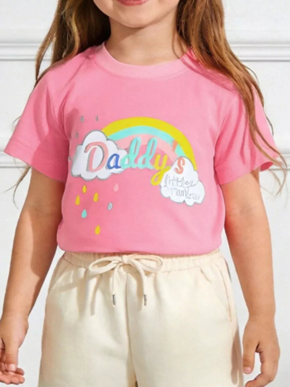 Pink t-shirt with rainbow and cloud graphic, short sleeves, crew neck.
