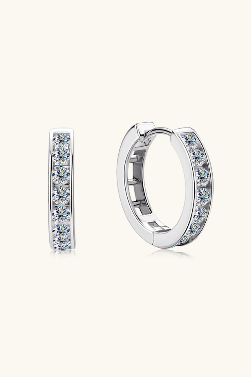 Silver moissanite channel-set hoop earrings with sparkling stones.