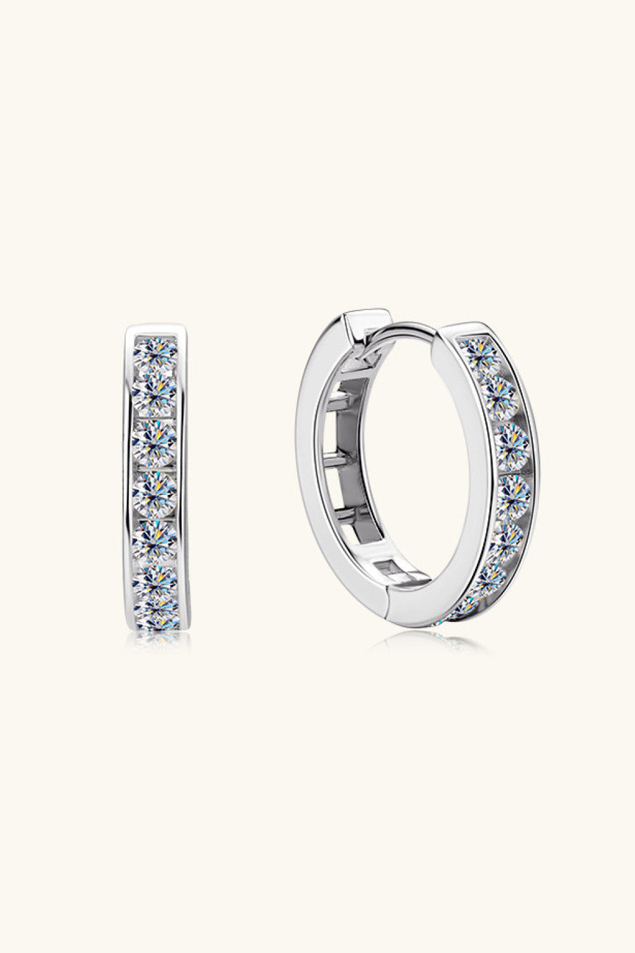 Silver moissanite channel-set hoop earrings with sparkling stones.