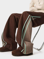 Brown joggers with side stripe detail and drawstring waist.