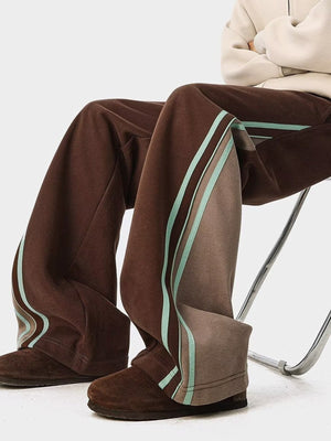 Brown joggers with side stripe detail and drawstring waist.