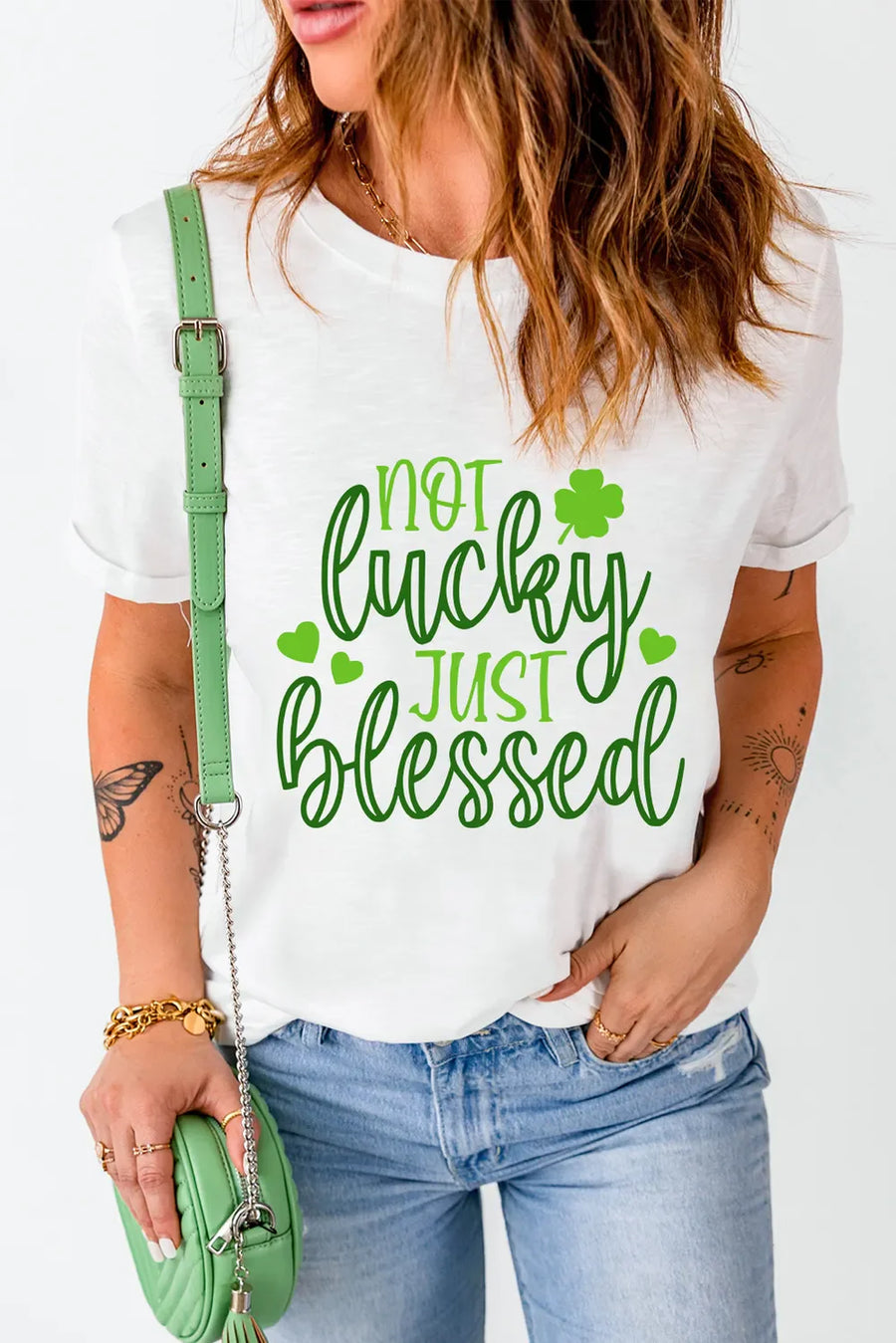 White t-shirt with green text that says Not Lucky Just Blessed and shamrock graphics.
