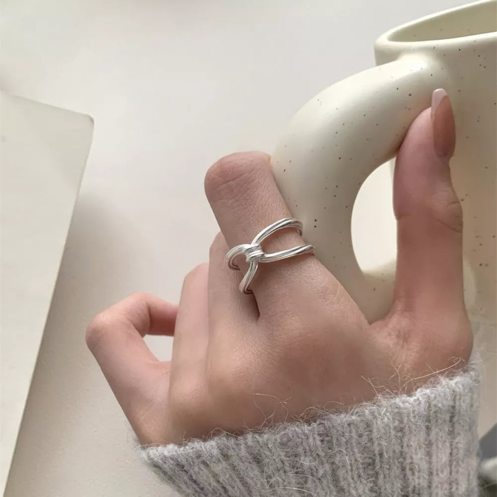 ring in silver featuring knot detail and knot fit