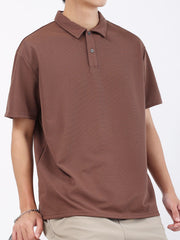 Brown textured performance polo shirt for men with short sleeves and a two-button placket.
