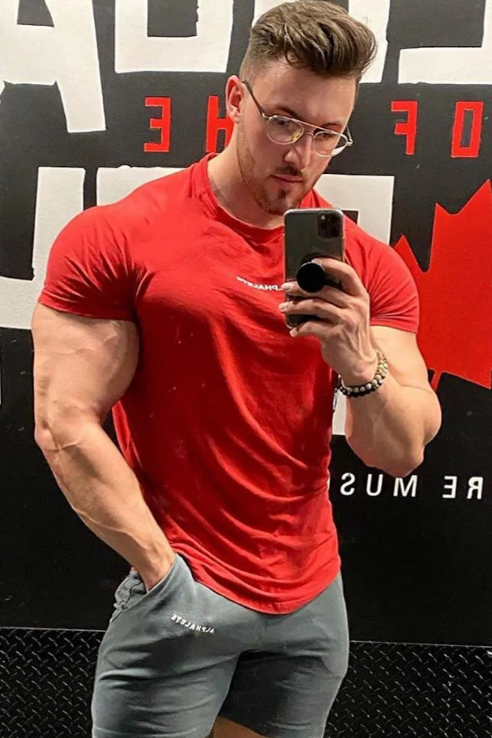 Red crew neck athletic t-shirt with a small white logo detail.