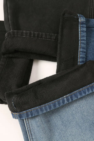 Oversized denim trousers in medium wash with black fleece lining detail.
