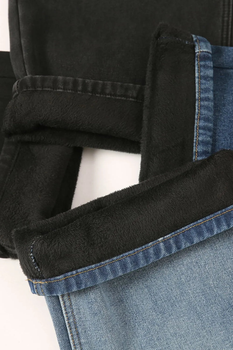 Oversized denim trousers in medium wash with black fleece lining detail.