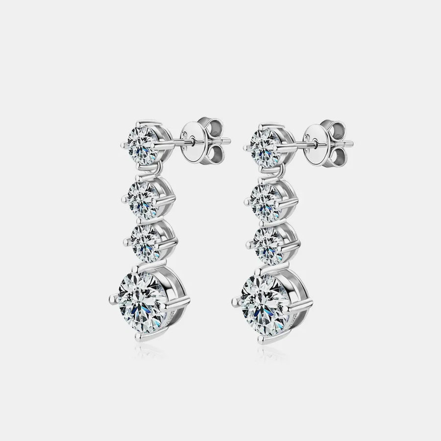 Silver cascade cubic zirconia drop earrings with three round stones each.